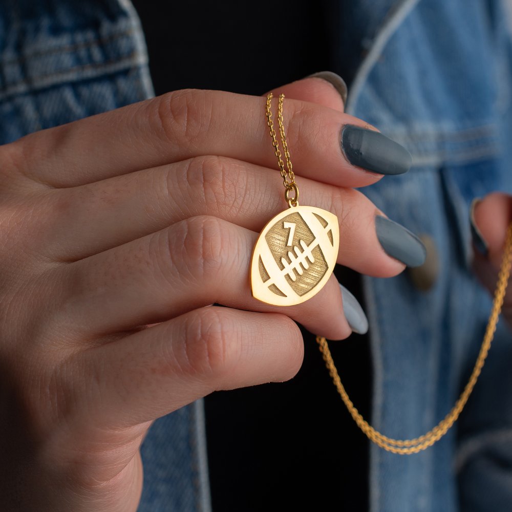 Dainty football necklace for boys, a stylish and lightweight jewelry piece.