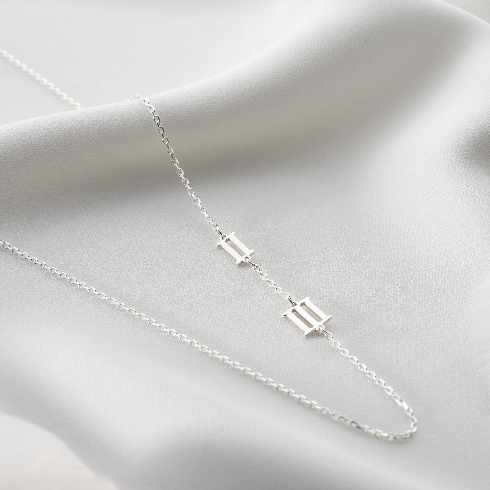 Engraved Roman number necklace featuring a personalized date on the side