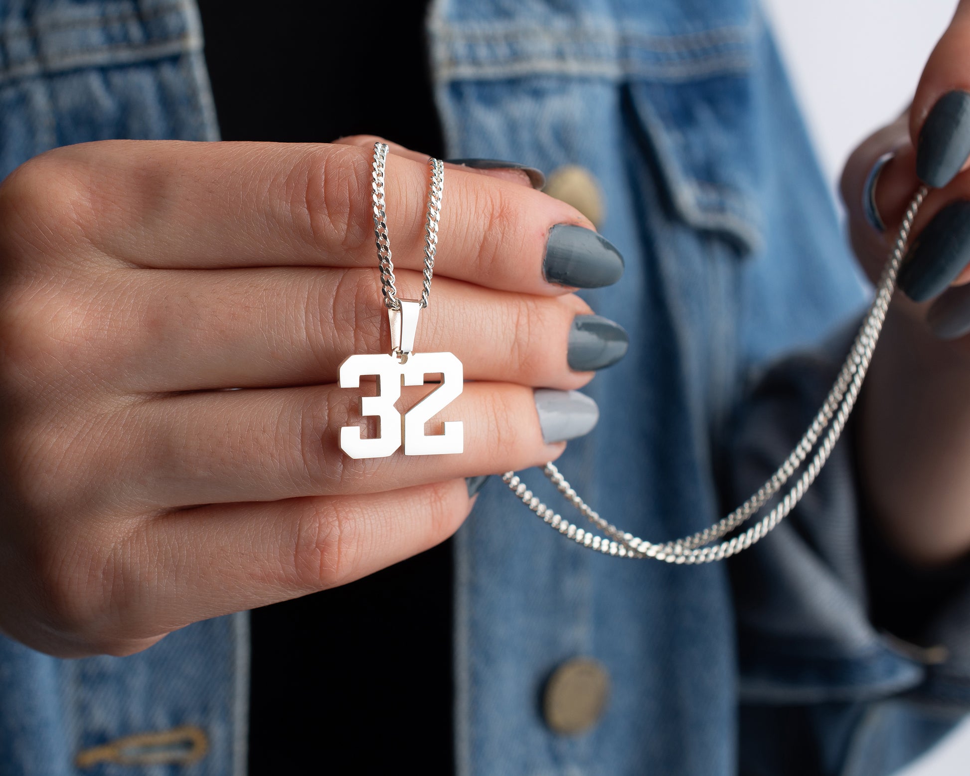 Engraved sports number necklace customized for athletes and fans.